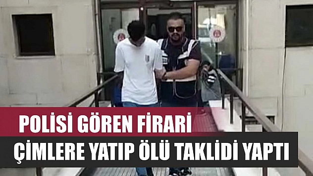 Polisi gören firari, çimlere yatıp ölü taklidi yaptı