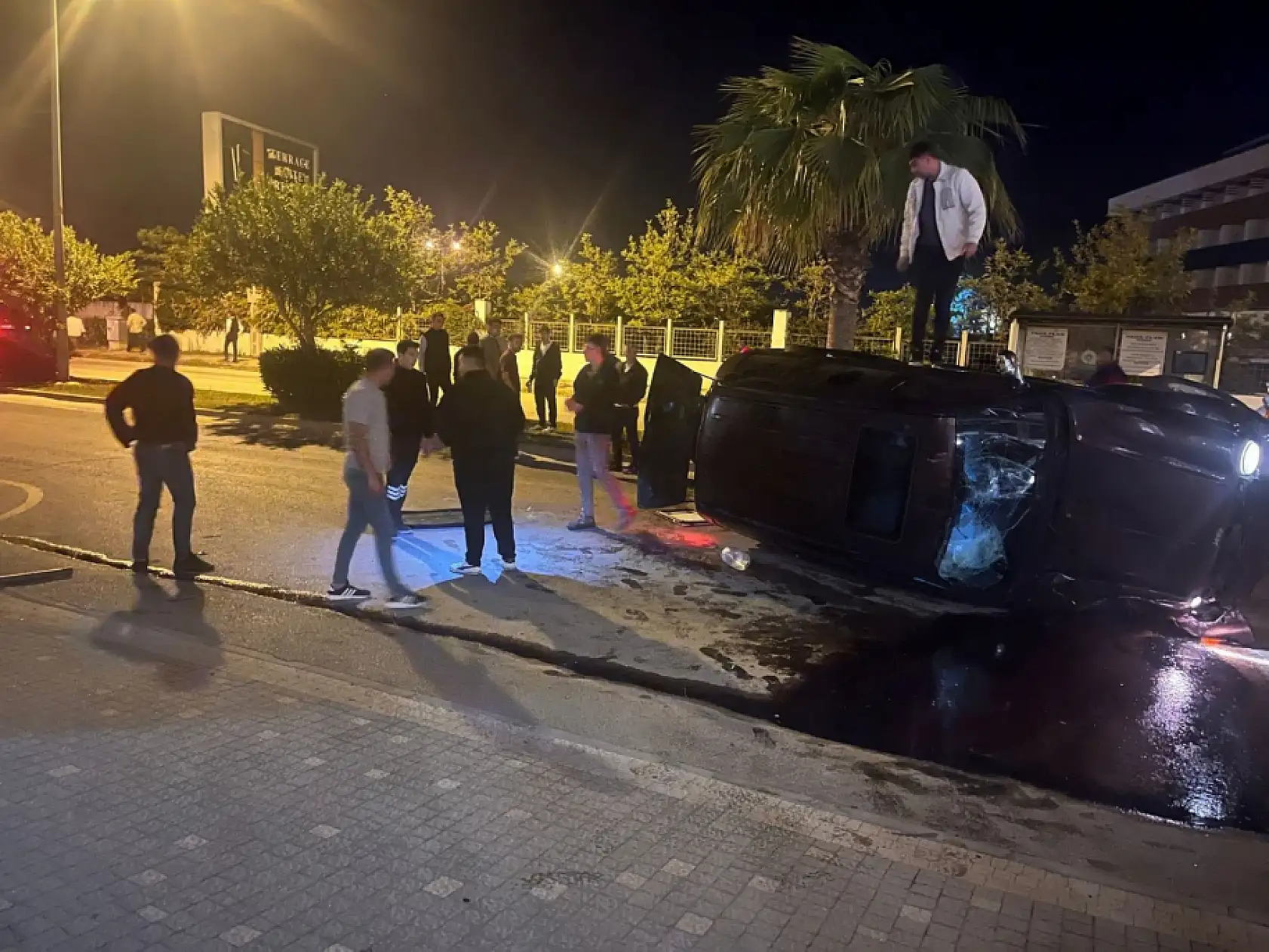 Devrilen otomobildekilerin çıkarılma anlarını film izler gibi izlediler