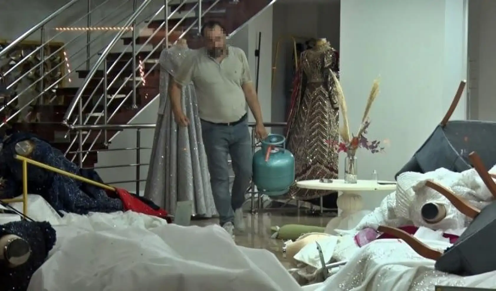 Eşinin mağazasına girip gelinliklerin üzerlerine kolonya döktü, tüpe çakmağı dayayınca tazyikli suyu yedi