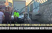 Korkulukları yıkan otomobil duvarda asılı kaldı, sürücü burnu bile kanamadan kurtuldu