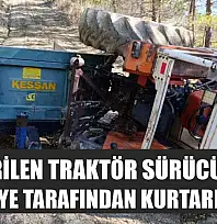 Devrilen traktör sürücüsü itfaiye tarafından kurtarıldı