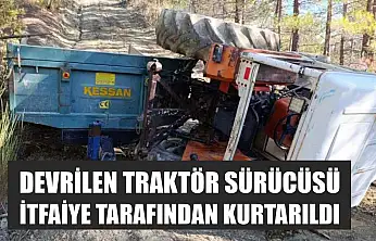 Devrilen traktör sürücüsü itfaiye tarafından kurtarıldı