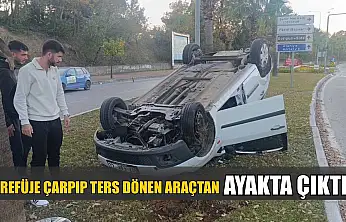 Refüje çarpıp ters dönen araçtan ayakta çıktı