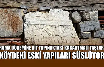 Roma dönemine ait tapınaktaki kabartmalı taşlar köydeki eski yapıları süslüyor
