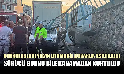 Korkulukları yıkan otomobil duvarda asılı kaldı, sürücü burnu bile kanamadan kurtuldu