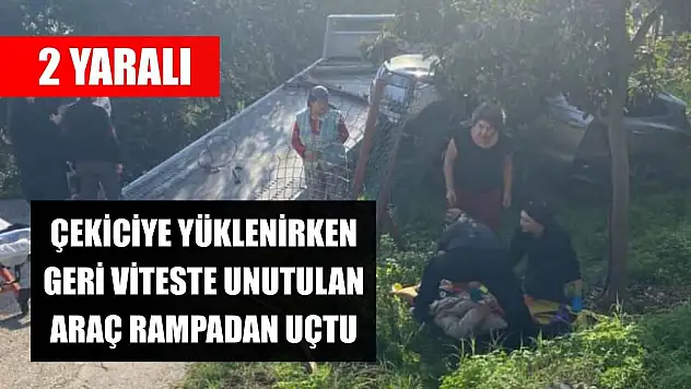 Çekiciye yüklenirken geri viteste unutulan araç rampadan uçtu: 2 yaralı
