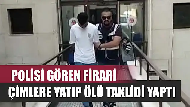 Polisi gören firari, çimlere yatıp ölü taklidi yaptı