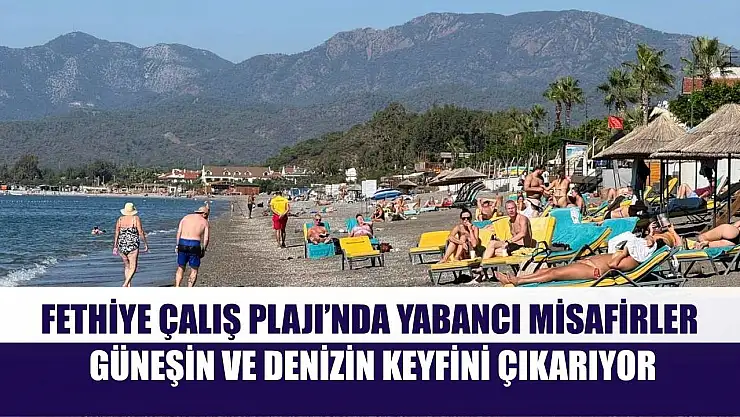 Fethiye Çalış Plajı'nda yabancı misafirler güneşin ve denizin keyfini çıkarıyor