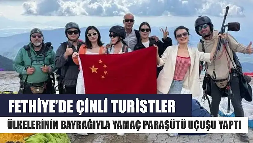 Fethiye'de Çinli turistler ülkelerinin bayrağıyla yamaç paraşütü uçuşu yaptı