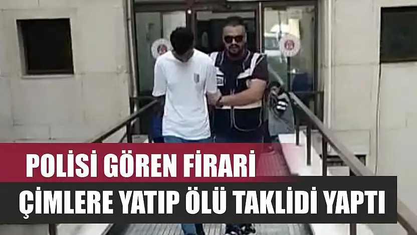 Polisi gören firari, çimlere yatıp ölü taklidi yaptı