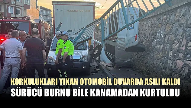 Korkulukları yıkan otomobil duvarda asılı kaldı, sürücü burnu bile kanamadan kurtuldu