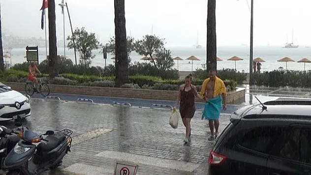 Yağmura aldırmayan turistler denizin keyfini çıkardı