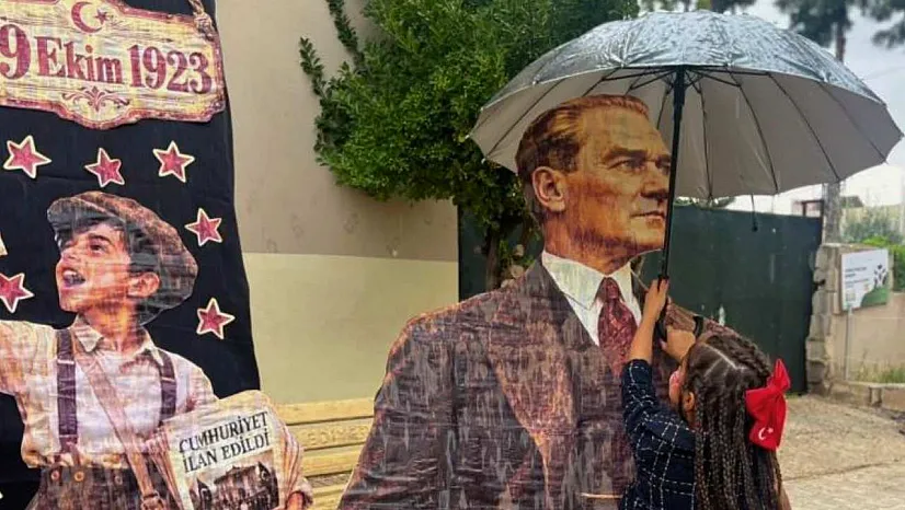 Yağmura aldırış etmeden Atasına şemsiye tutan küçük kızın davranışı yürekleri ısıttı