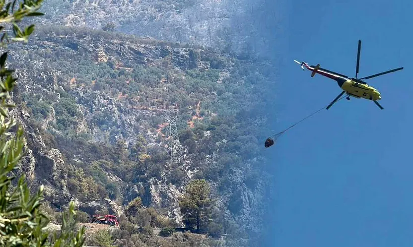 Fethiye'deki orman yangını sonrası soğutma çalışmaları havadan ve karadan sürüyor